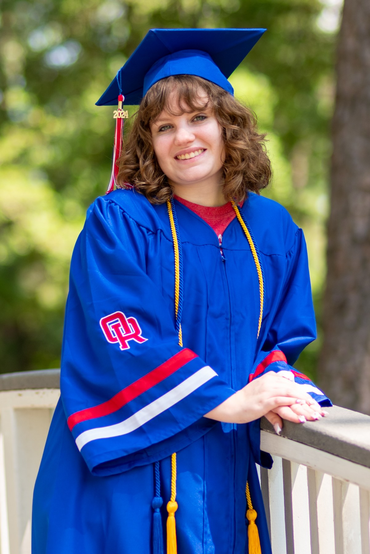 Senior graduate portrait along a railing, Fort Collins Colorado